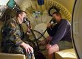 Navy divers testing built-in breathing masks inside a recompression chamber
